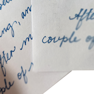 A close-up of two pages of a handwritten letter with blue ink in Spencerian-style cursive script on white paper, showing partial words and phrases including "couple of" and "After."